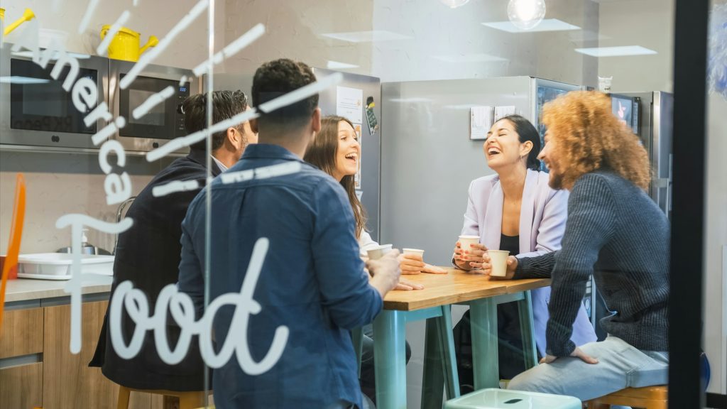 Businesspeople having coffee break in canteen at office