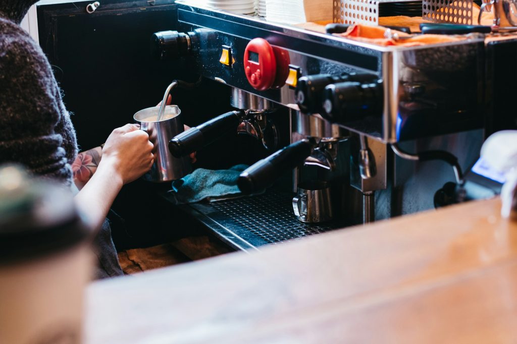Professional coffee maker in shop